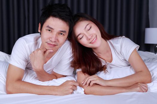 happy young couple on bed in the bedroom