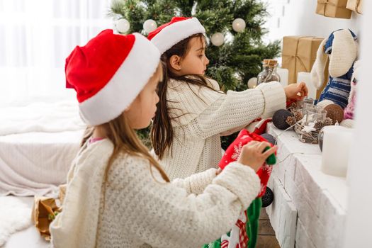 Two little girls in Christmas background.