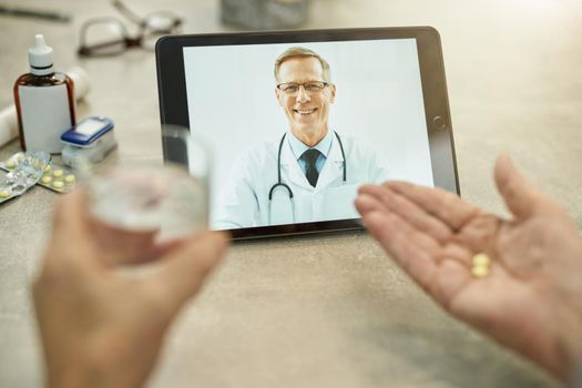 Cropped photo of medical doctor video-calling patient taking his pills with water at home