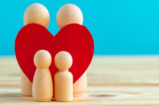 Wooden little figures of people close up. Family concept