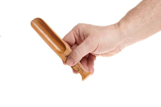 Hand holds a small wooden scoop for cereals on a white background, a template for designers.