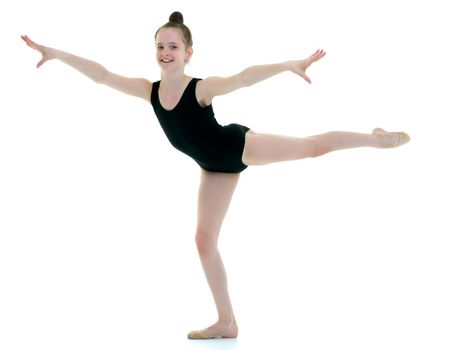 A girl gymnast performs an acrobatic element. The concept of childhood, sport, healthy lifestyle. Isolated on white background.