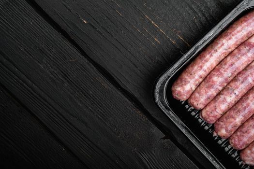 Fresh Polish Sausages pack set, on black wooden table background, top view flat lay, with copy space for text