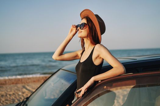 woman on the beach near car travel adventure summer. High quality photo