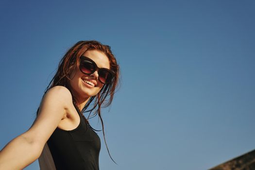 woman in black swimsuit sunglasses sun nature. High quality photo