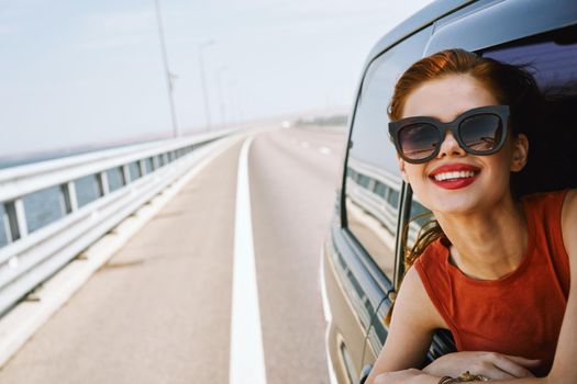woman looking out of car window wearing sunglasses travel lifestyle. High quality photo