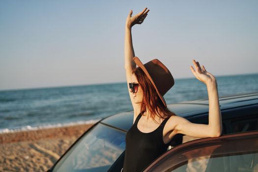 woman on the beach is with a car wearing sunglasses travel. High quality photo