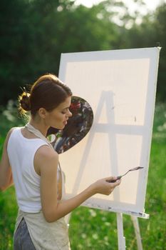 woman artist outdoors paint palette painting landscape. High quality photo