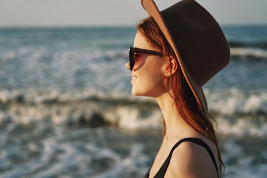 woman walking on the beach hat travel vacation sun. High quality photo