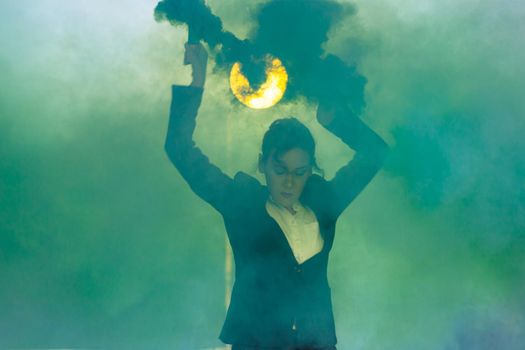 Pasadoble, latin solo dance and contemporary dance - Young beautiful female dancing into smoke cloud.