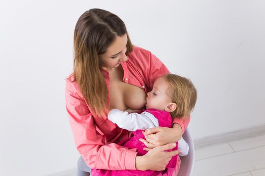 Mother breast feeding and hugging her baby.