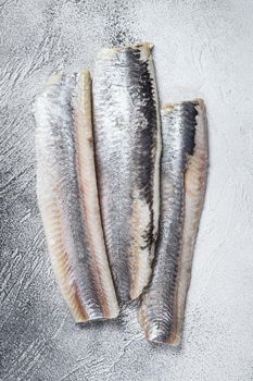 Pickled marinated sea herring fillet. White background. Top view.