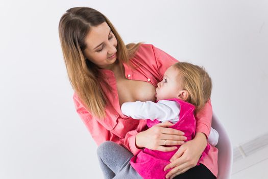 Mother breast feeding and hugging her baby.