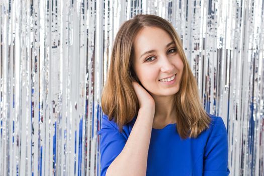 Beautiful girl with healthy long hair over shiny holiday background.