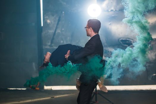 Pasadoble, latin solo dance and contemporary dance - Handsome man and woman dancing into smoke cloud