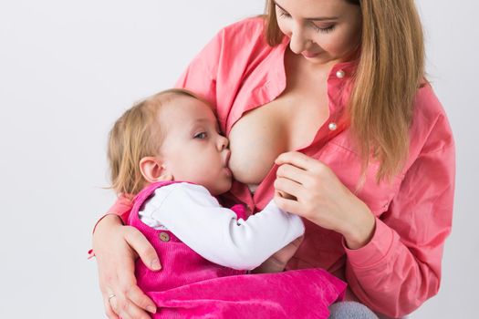 Mother breast feeding and hugging her baby.