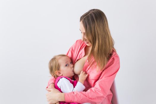 Motherhood concept - Mother and baby lactation on white background