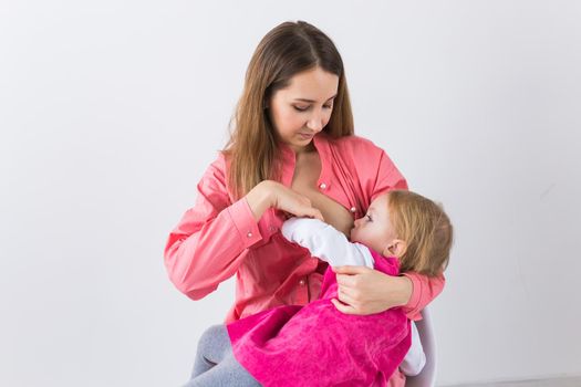 Motherhood concept - Mother and baby lactation on white background