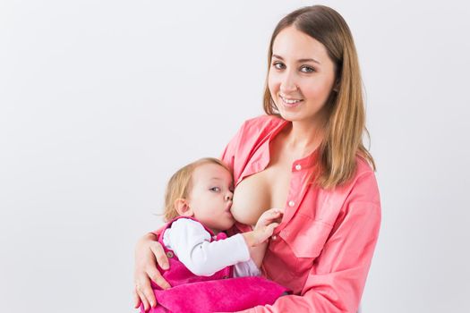 Mother breast feeding and hugging her baby.