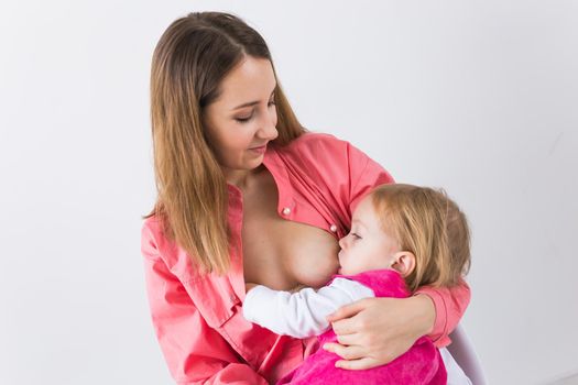 Motherhood concept - Mother and baby lactation on white background