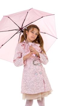 Beautiful girl walking under an umbrella, smiling girl posing in the studio, cheerful teenager in stylish clothes walking on a white background