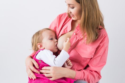 Mother breast feeding and hugging her baby.