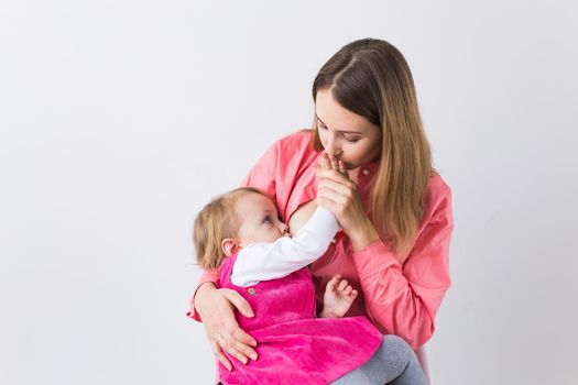 Motherhood concept - Mother and baby lactation on white background