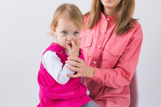 little girl pick in finger in the nose.