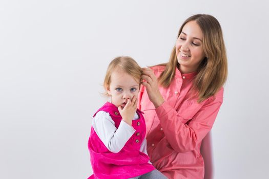 little girl pick in finger in the nose.