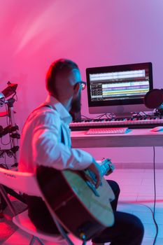 Musician and making music concept - Male sound producer working in recording studio