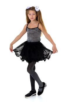 Girl with pigtails in fashionable clothes. Pretty blonde girl in black lace skirt and tank top posing in studio against white background. Full length portrait of preteen child