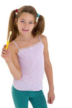 Smiling girl standing with toothbrush in her hands. Preteen girl brushing her teeth before or after sleeping. Cute child daily routine concept