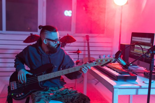 Musician and making music concept - Male sound producer working in recording studio