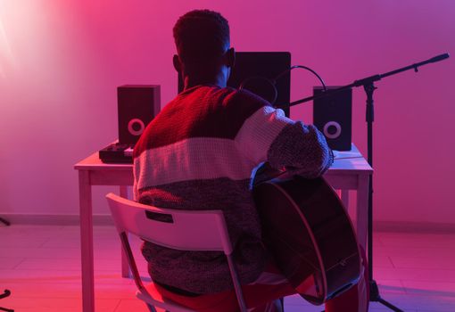 Musician and making music concept - Male sound producer working in recording studio