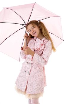 Beautiful girl walking under an umbrella, smiling girl posing in the studio, cheerful teenager in stylish clothes walking on a white background
