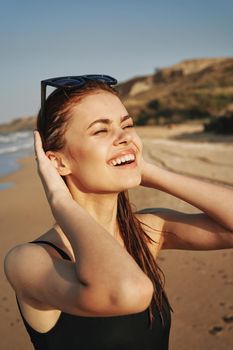 cheerful woman sunglasses posing black swimsuit island. High quality photo