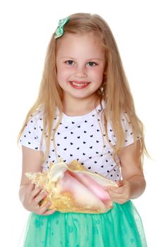 A little girl with a sea shell. The concept of a family vacation at sea, ecology. Isolated on white background.