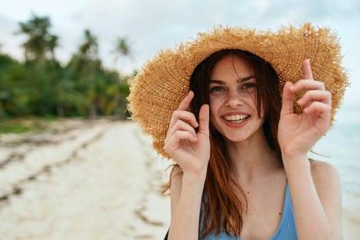 cheerful woman in a beach hat by the ocean island summer. High quality photo