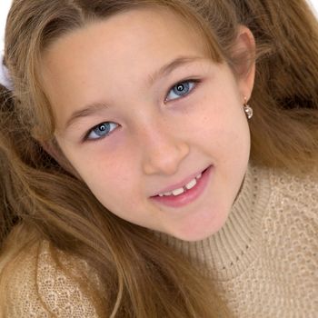 Beautiful little girl close-up. The concept of beauty and fashion, happy childhood. Isolated on white background.