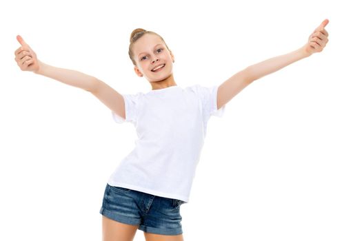 A beautiful girl in a clean white T-shirt is holding a thumb up. The concept can be used to advertise goods and services, whose logo can be printed on the surface of the shirt. Isolated on white background.