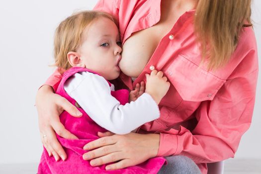 Mother breast feeding and hugging her baby.