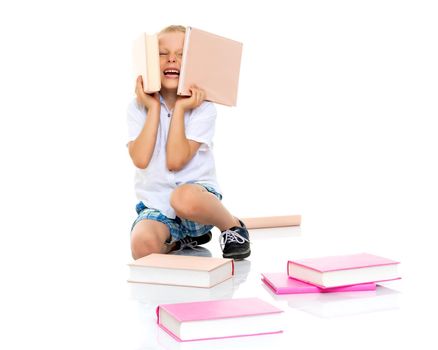 A cute little boy, a preschooler with books. The concept of education, the intellectual development of the child in the family. Isolated on white background.