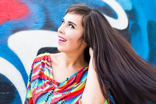 Happiness and craziness. Smiling funny girl have fun outdoor and dances. Young attractive woman with waving long hair playing in summer park