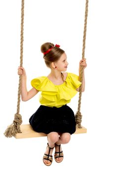 Happy little girl gaily swinging on a swing. The concept of a summer vacation in nature, a family vacation with the family on the beach or the sea. Isolated on white background.