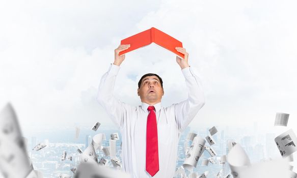 Senior businessman holding open diary overhead. Man in shirt and tie standing on cityscape background with falling paper documents. Paperwork and bureaucracy concept. Time management and planning.