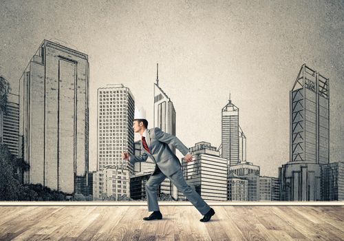 Young handsome businessman wearing white paper crown running in a hurry