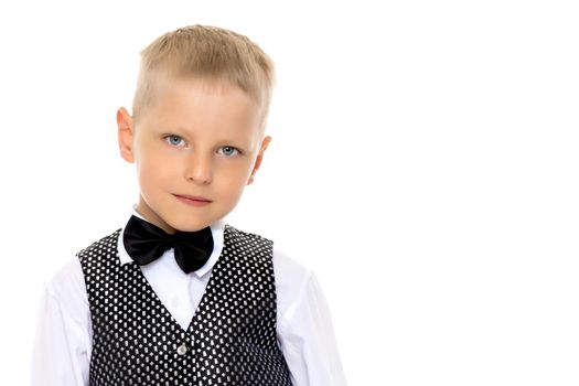 A cute little boy in a suit and a waistcoat with a butterfly. The concept can be used to advertise holidays, fashion shows. Isolated on white background.