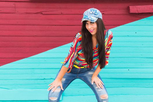 Street dance, freestyle and jazz funk concept - Beautiful girl dancing hip-hop over red and blue brick wall.