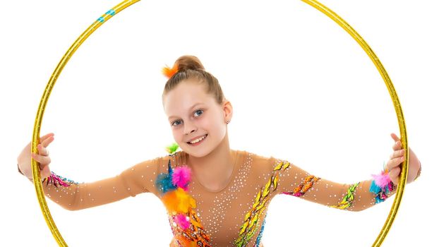 A girl gymnast performs an exercise with a hoop. The concept of gymnastics and fitness. Isolated on white background.