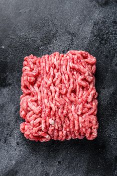 Raw mince beef, ground meat. Black background. Top view.